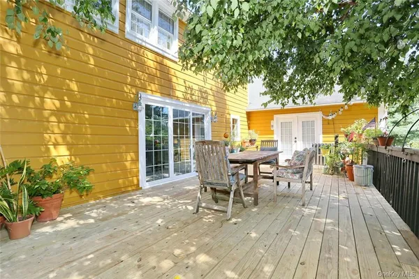 a view of a patio with table and chairs and potted plants