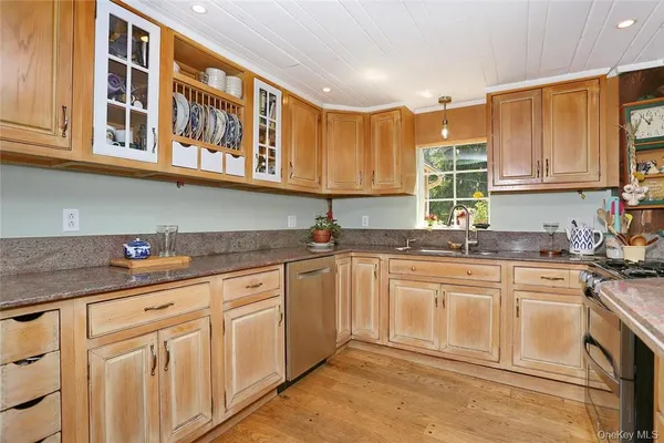 a kitchen with stainless steel appliances granite countertop a sink and cabinets