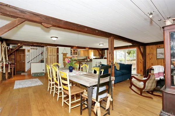 a dining room with furniture and wooden floor