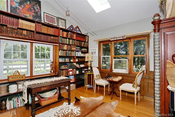 a reading room with furniture and a book shelf
