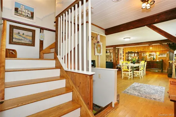 a view of entryway livingroom and hall with wooden floor