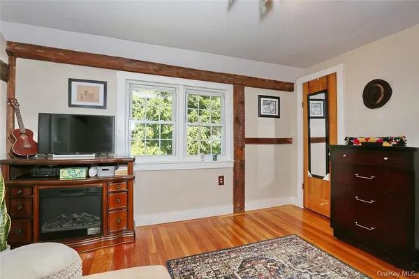 a living room with furniture a flat screen tv and a fireplace