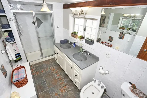 a bathroom with a sink toilet and mirror