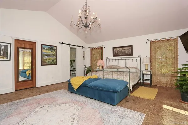 a bedroom with a bed and a chandelier