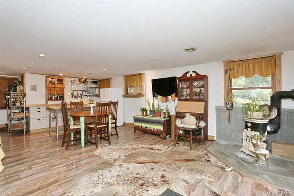 a living room with furniture a rug and a floor to ceiling window