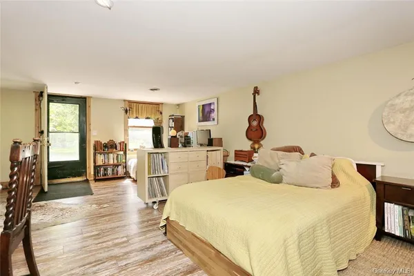 a bedroom with large bed a chandelier and a window