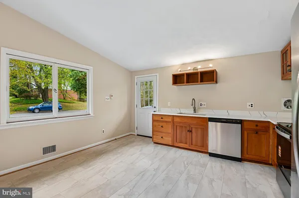 a view of a kitchen with wooden floor and a sink