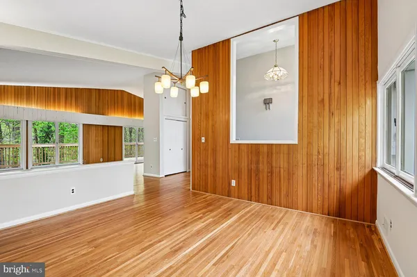 a view of empty room with a window and ceiling fan