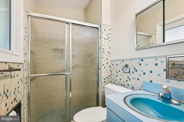 a view of empty room with window and wooden floor