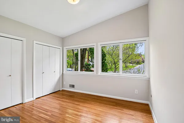 a view of an empty room with wooden floor