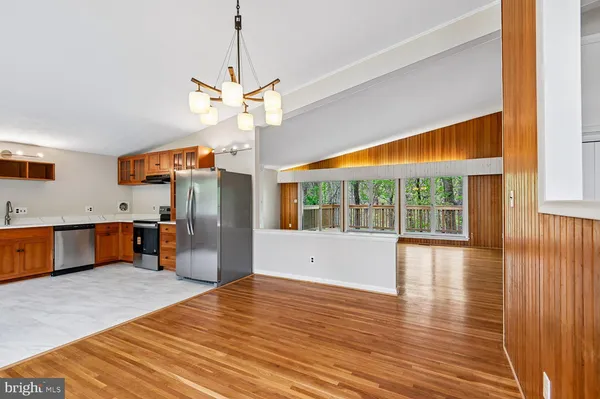 a view of empty room with wooden floor and fireplace