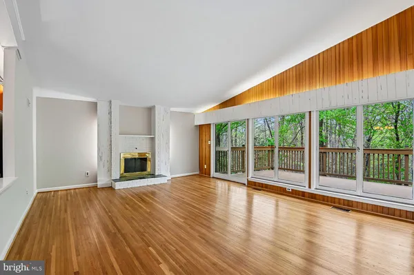a view of room with wooden floor and windows