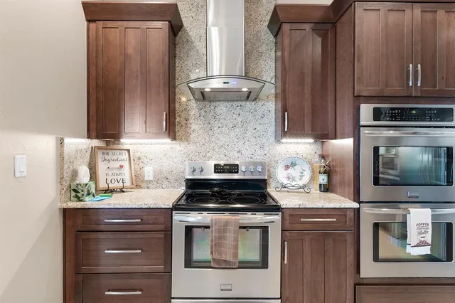 a kitchen with stainless steel appliances granite countertop a stove and a microwave