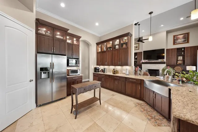 a kitchen with stainless steel appliances granite countertop a refrigerator and a sink