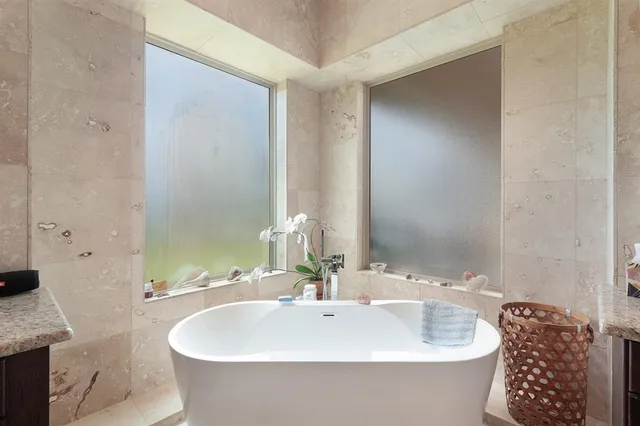 a white bath tub sitting in a bathroom