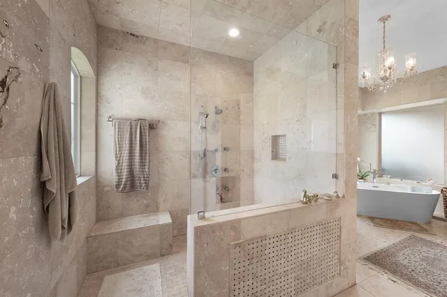 a bathroom with a granite countertop sink a toilet a mirror and shower