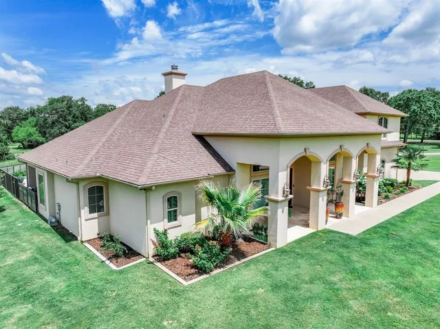 a front view of a house with a garden and plants