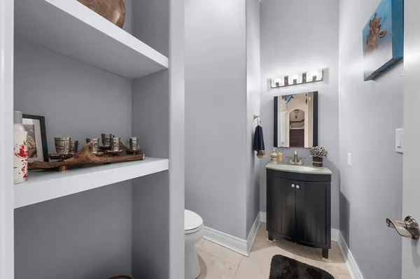 a bathroom with a sink a toilet and mirror
