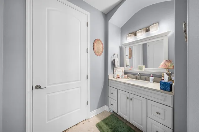a bathroom with a double vanity sink and mirror