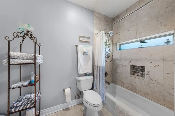 a bathroom with a granite countertop toilet a sink and bathtub