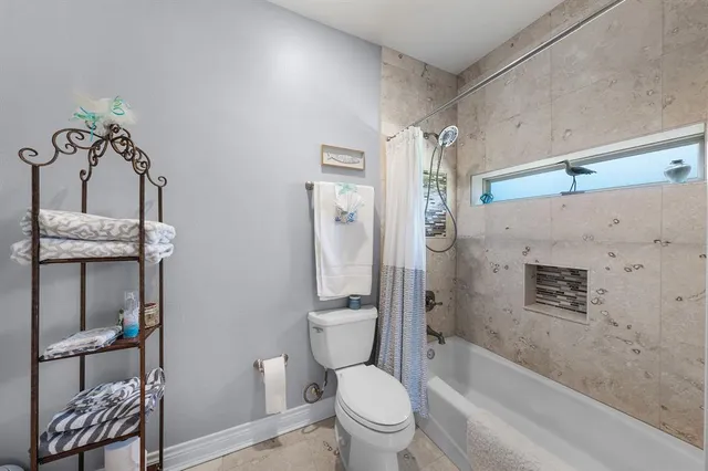 a bathroom with a granite countertop toilet a sink and bathtub