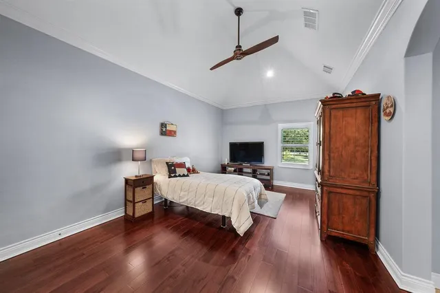 a bed room with furniture and a flat screen tv