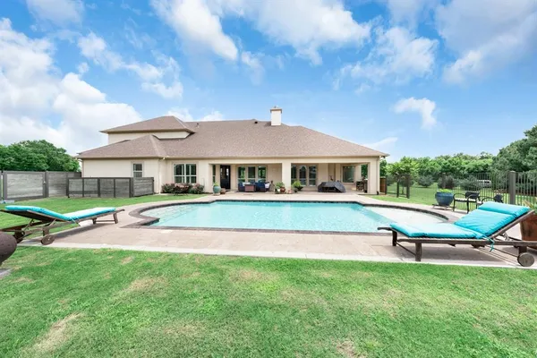 a aerial view of a house with a yard table and chairs