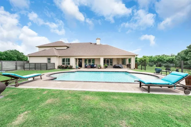 a aerial view of a house with a yard table and chairs