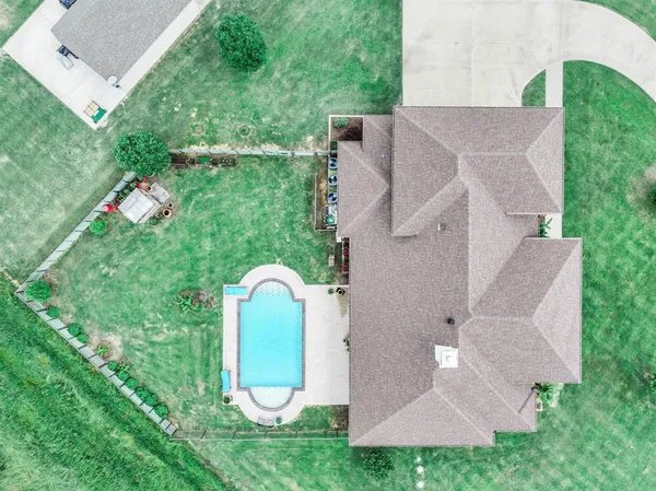 a view of a house with swimming pool and yard