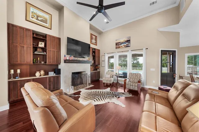 a living room with furniture a flat screen tv and a fireplace