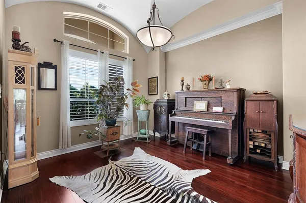 a living room with furniture a fireplace and wooden floor