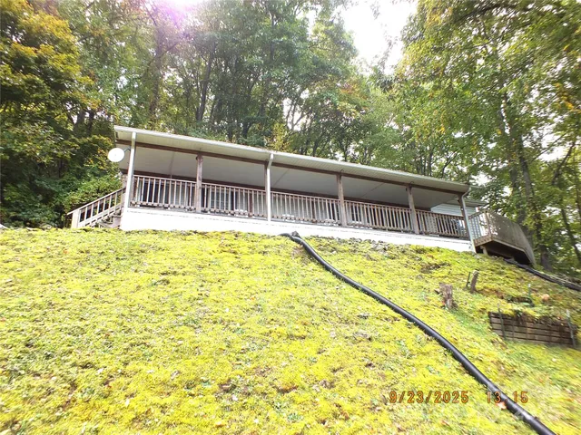 a house view with swimming pool in front of it