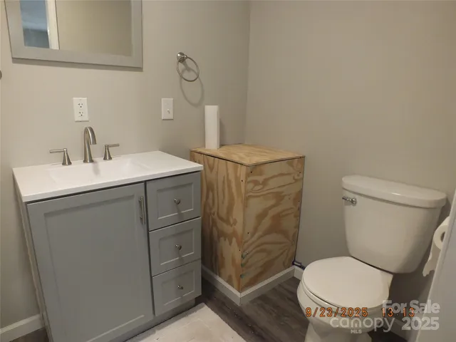 a bathroom with a sink toilet and a mirror