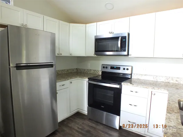 a kitchen with a refrigerator stove and microwave