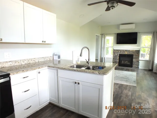 a kitchen with white cabinets appliances and a sink