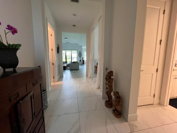 a view of a hallway and dining room