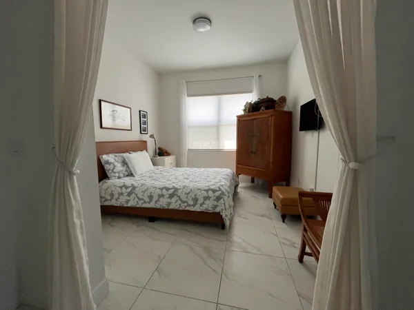 a bedroom with a bed and dresser