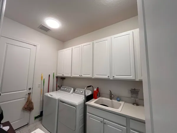 a view of storage and utility room with washer and dryer