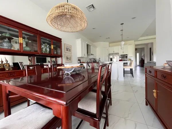 a living room with lots of furniture and a dining table