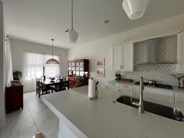 a kitchen with sink refrigerator and cabinets