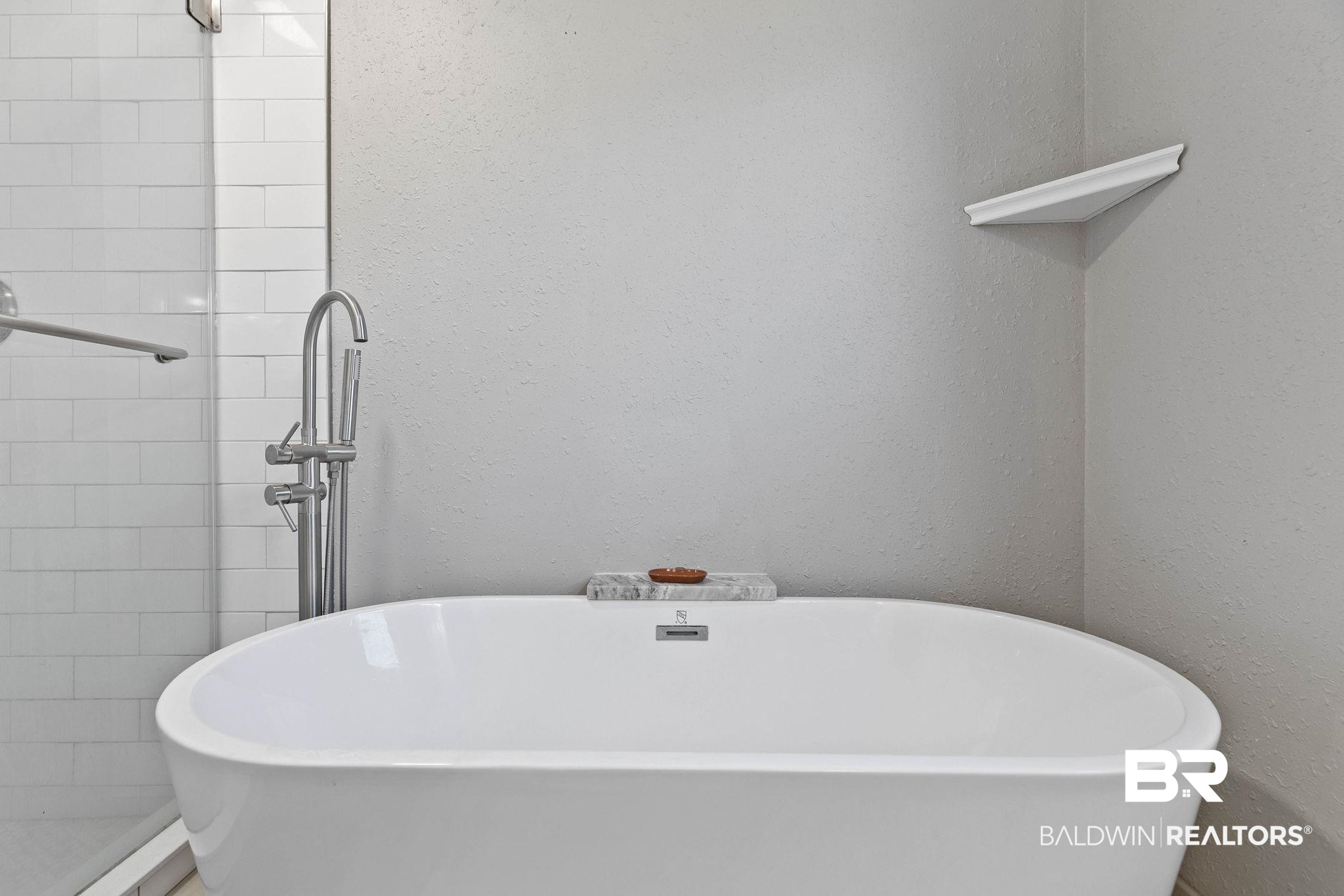 16796 Thompson Road Loxley, AL 36551 - Photo 45 of 93 Full bathroom featuring a freestanding tub, a shower stall, and a textured wall