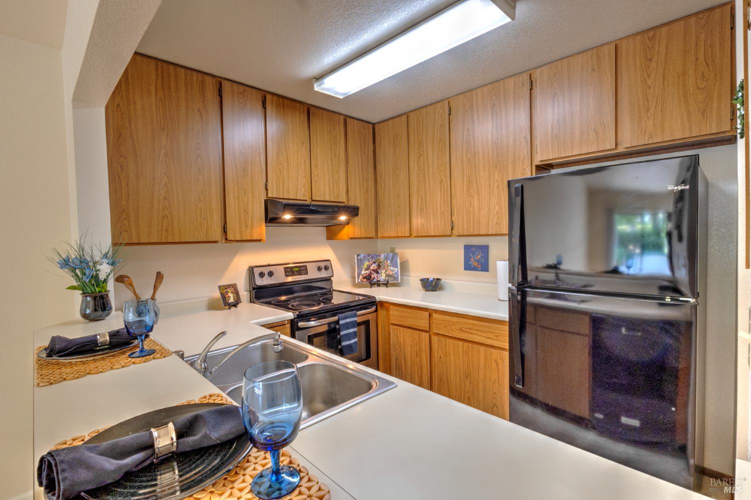 539 Norlee Street Sebastopol, CA 95472 - Photo 7 of 26 Kitchen with matching range, range hood, dishwasher, and refrigerator.