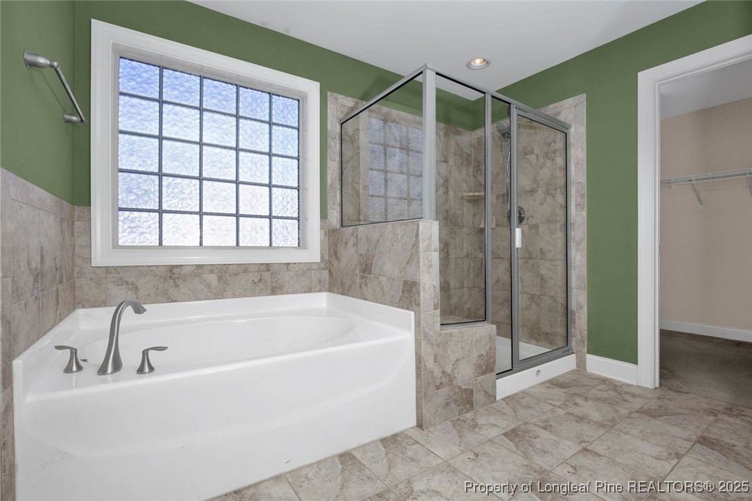 89 Revolutionary Road Cameron, NC 28326 - Photo 17 of 37 a bathroom with a bathtub and shower