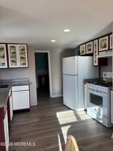 a kitchen with stainless steel appliances a refrigerator and a stove top oven