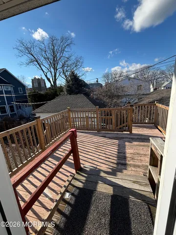 a view of balcony with wooden floor and fence