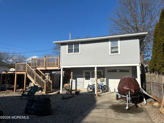 a view of a patio with table and chairs and a barbeque