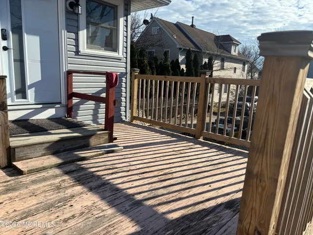 a view of a street with wooden fence