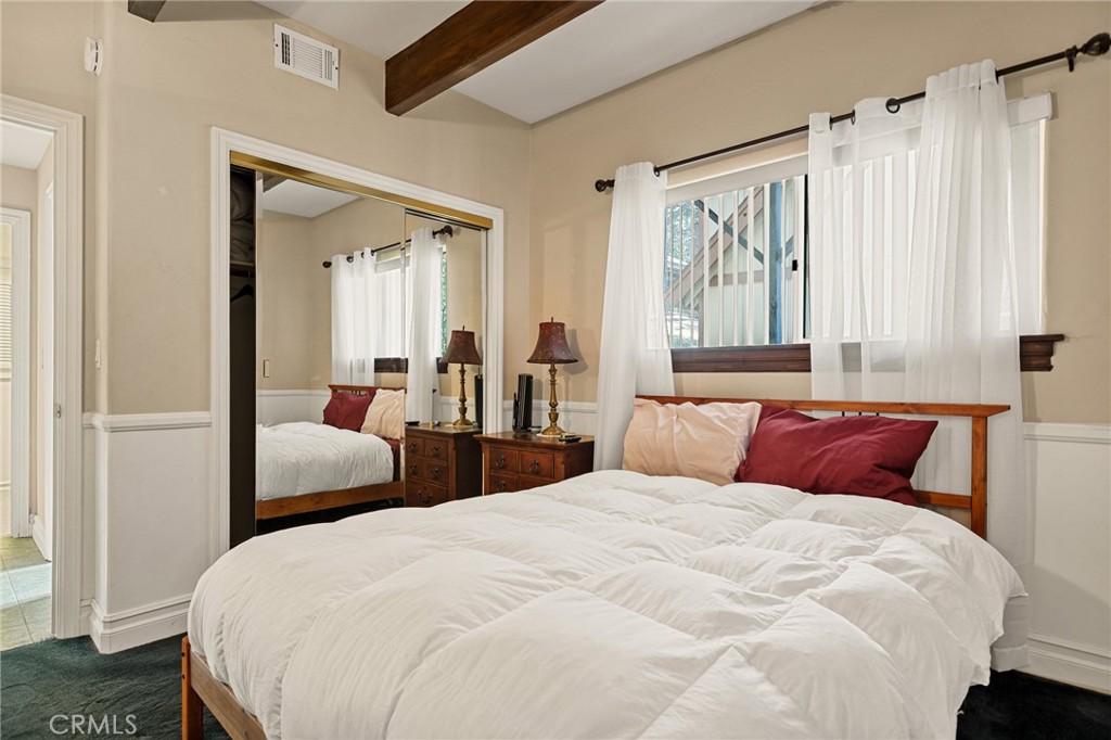 1055 Meadow Brook Road Lake Arrowhead, CA 92352 - Photo 15 of 27 a bedroom with bed and large window