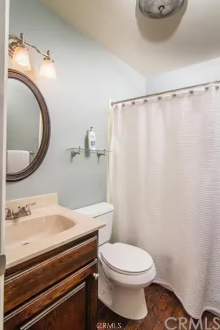 1055 Meadow Brook Road Lake Arrowhead, CA 92352 - Photo 18 of 27 a bathroom with a sink a toilet and a mirror