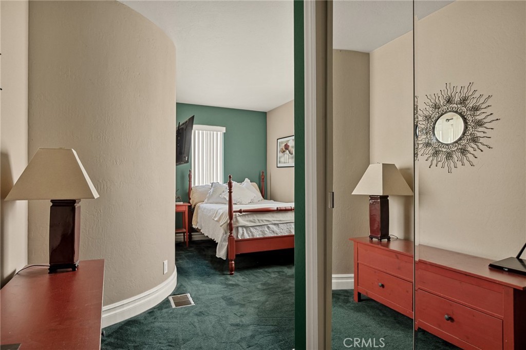 1055 Meadow Brook Road Lake Arrowhead, CA 92352 - Photo 19 of 27 a bedroom with a bed and a chandelier